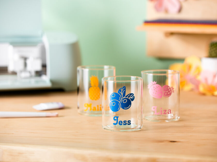 Three personalized drinking glasses sitting on a counter top